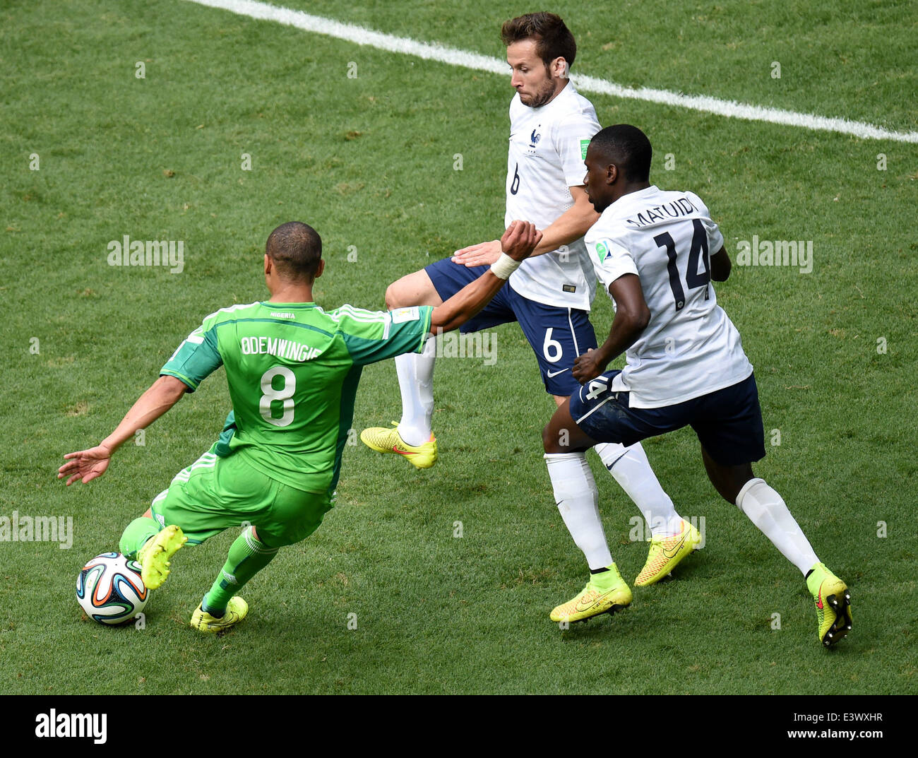 Brasilia, Brazil. 30th June, 2014. Nigeria's Peter Osaze Odemwingie (L) vies with the France's Blaise Matuidi (R) and Yohan Cabaye during a Round of 16 match between France and Nigeria of 2014 FIFA World Cup at the Estadio Nacional Stadium in Brasilia, Brazil, on June 30, 2014. France won 2-0 over Nigeria and qualified for Quarter-finals here on Monday. Credit:  Liu Dawei/Xinhua/Alamy Live News Stock Photo