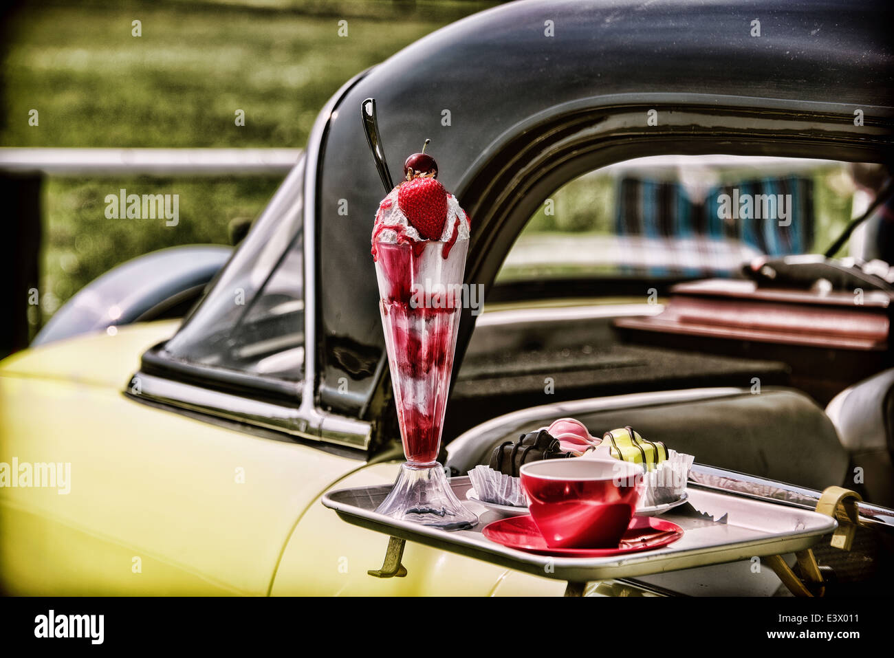 Vintage car with a window tray full of yummy treats Stock Photo