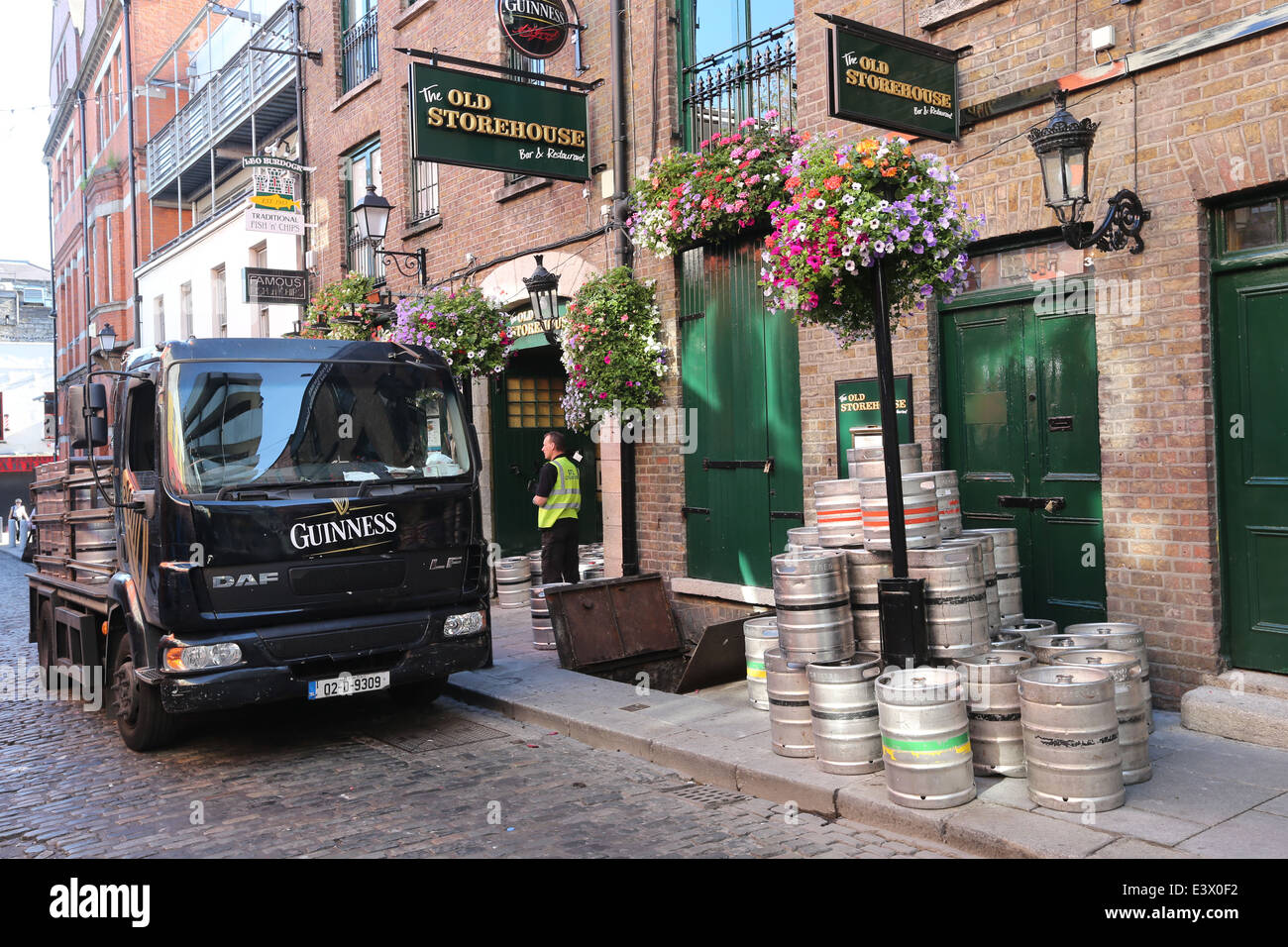 Kegs of Guinness are unloaded from a Guinness truck outside a pub in