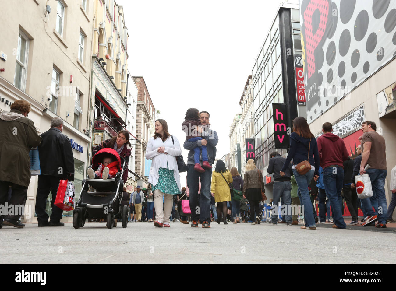 People walk on the new granite pavement of Grafton Street in Dublin city centre during a busy shopping period Stock Photo