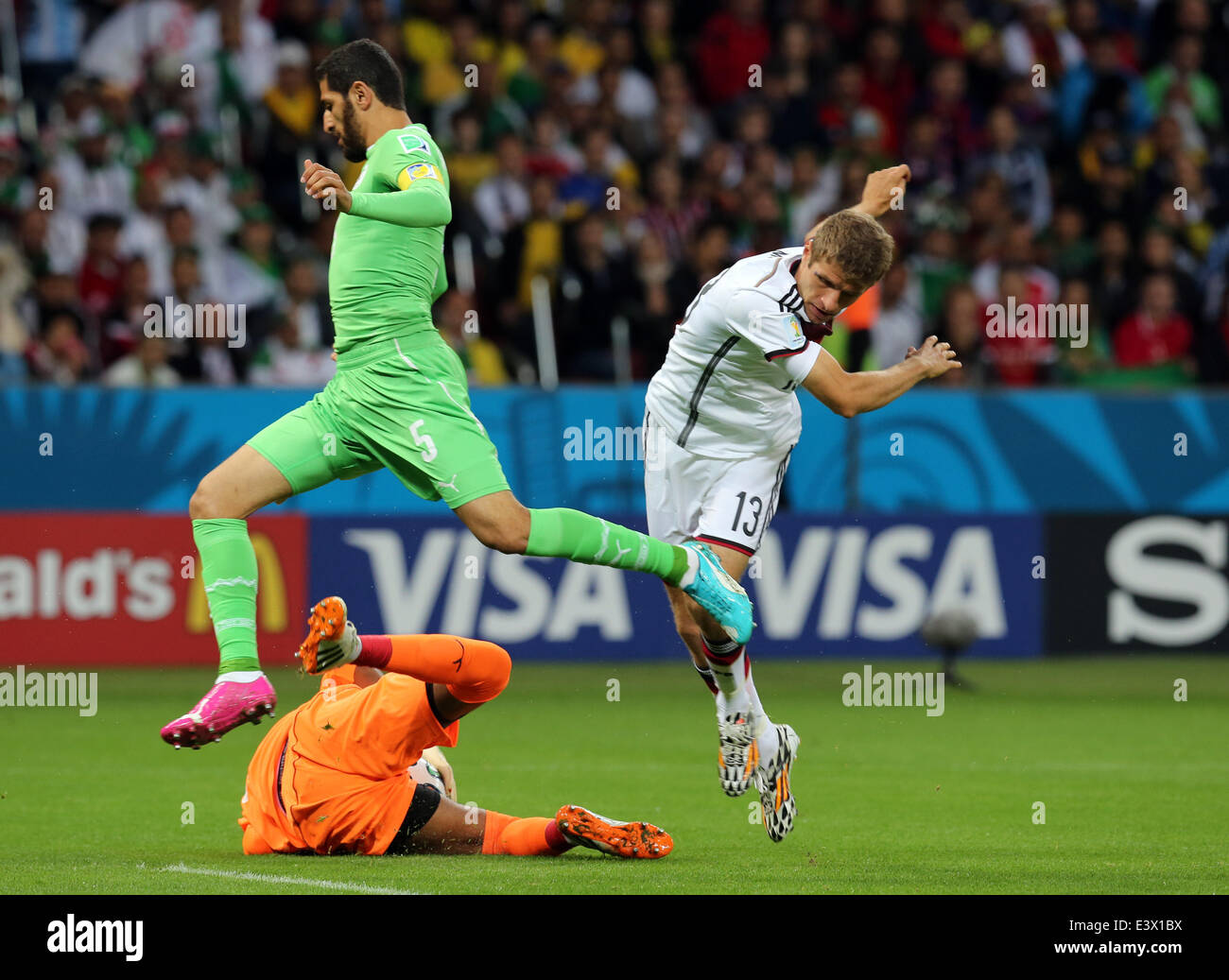 Porto Alegre, Brazil. 30th June, 2014. World Cup 2nd Round. Germany versus Algeria. Goalkeeper Mbohli saves the shot from Mueller watched by teammate Halliche Credit:  Action Plus Sports/Alamy Live News Stock Photo