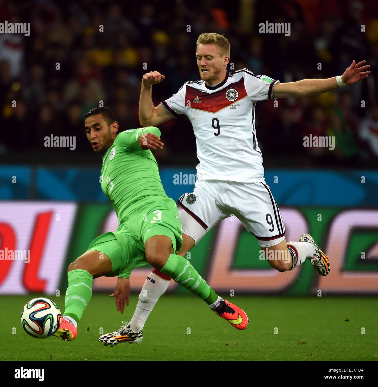 Porto Alegre, Brazil. 30th June, 2014. Algeria's Faouzi Ghoualm (L) vies with Germany's Andre Schurrle during a Round of 16 match between Germany and Algeria of 2014 FIFA World Cup at the Estadio Beira-Rio Stadium in Porto Alegre, Brazil, on June 30, 2014. Credit:  Li Ga/Xinhua/Alamy Live News Stock Photo