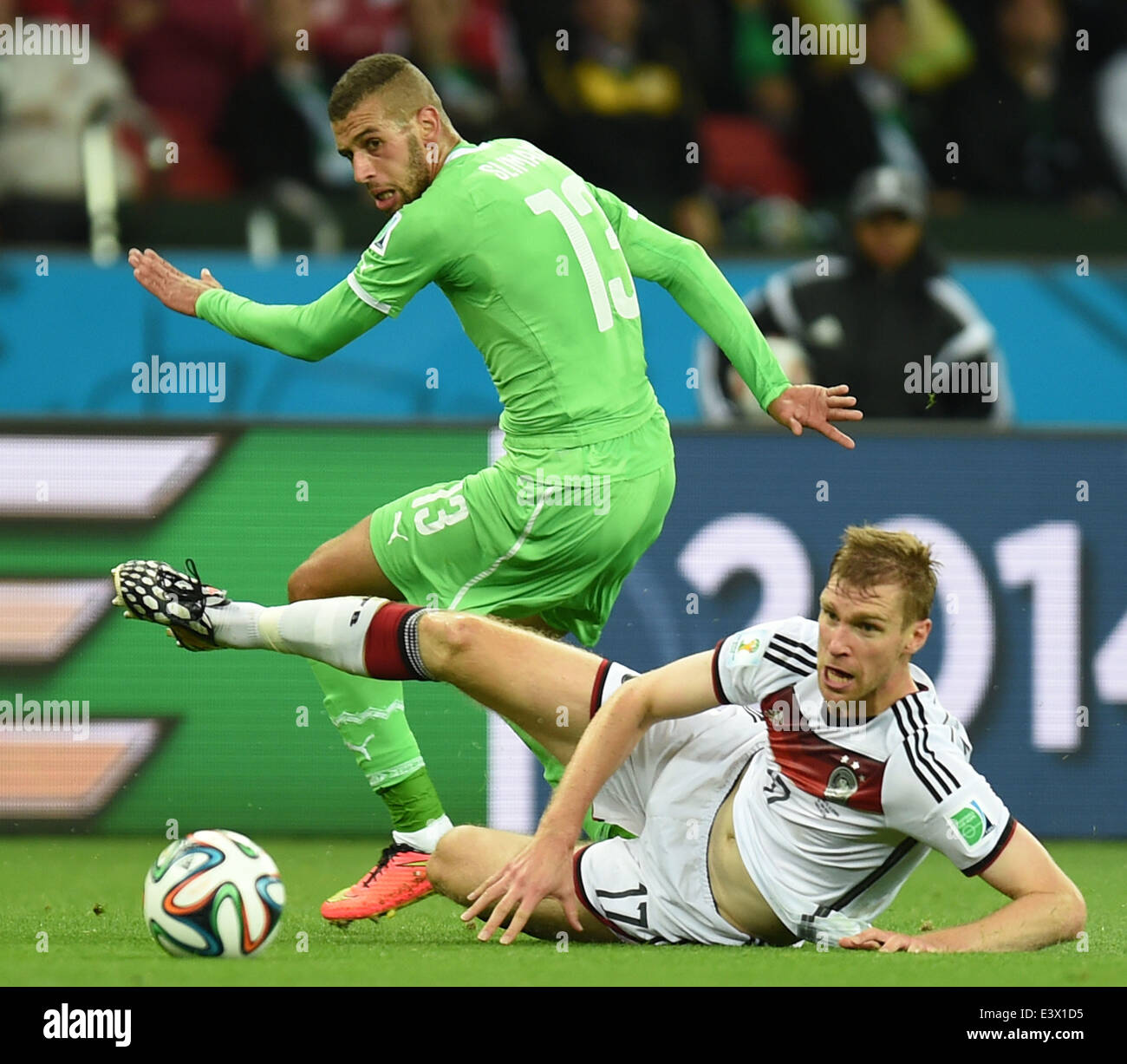 Porto Alegre, Brazil. 30th June, 2014. Algeria's Islam Slimani (L) vies with Germany's Per Mertesacker during a Round of 16 match between Germany and Algeria of 2014 FIFA World Cup at the Estadio Beira-Rio Stadium in Porto Alegre, Brazil, on June 30, 2014. Credit:  Li Ga/Xinhua/Alamy Live News Stock Photo