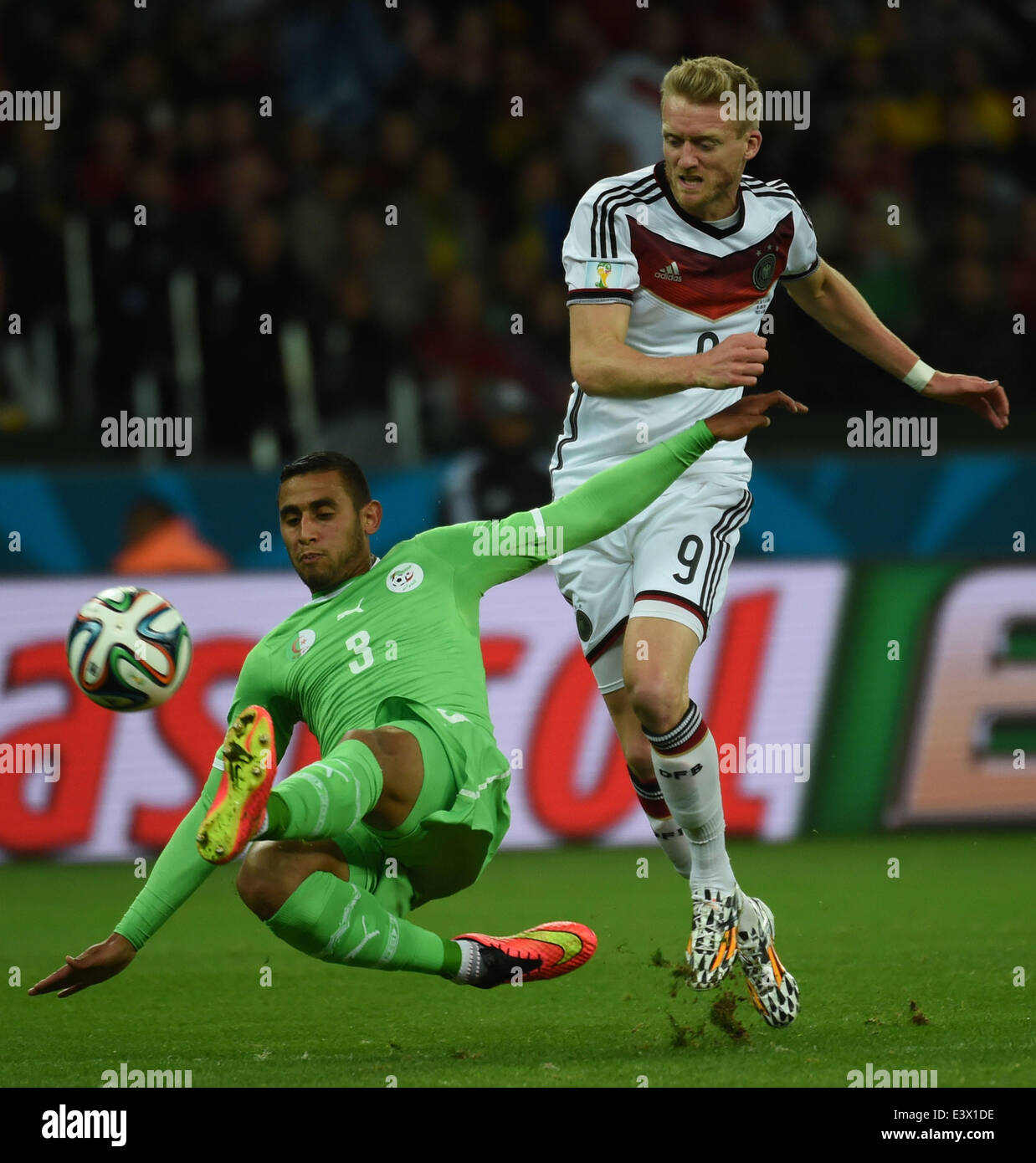 Porto Alegre, Brazil. 30th June, 2014. Algeria's Faouzi Ghoualm (L) vies with Germany's Andre Schurrle during a Round of 16 match between Germany and Algeria of 2014 FIFA World Cup at the Estadio Beira-Rio Stadium in Porto Alegre, Brazil, on June 30, 2014. Credit:  Li Ga/Xinhua/Alamy Live News Stock Photo