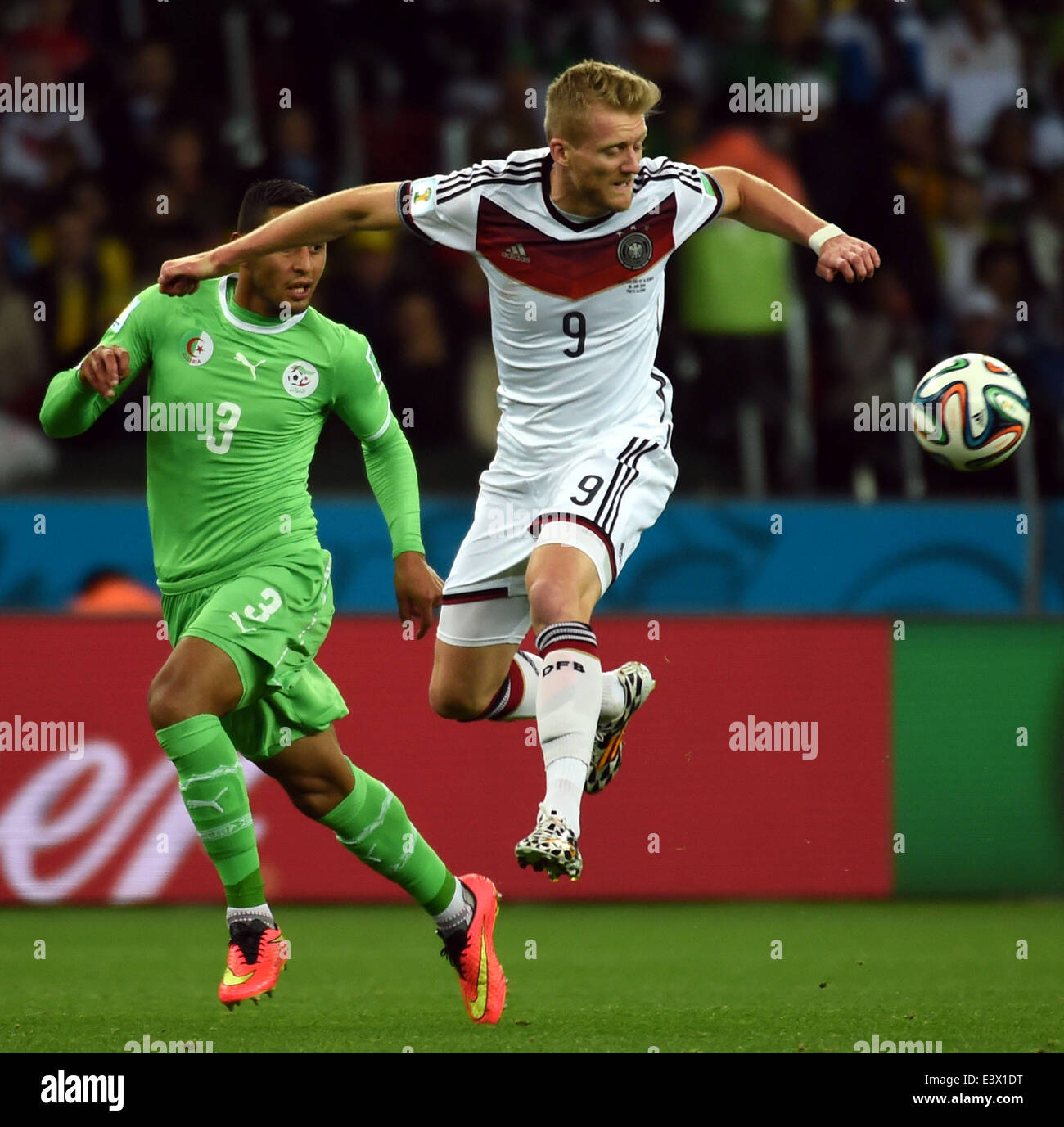 Porto Alegre, Brazil. 30th June, 2014. Germany's Andre Schurrle (R) vies with Algeria's Faouzi Ghoualm during a Round of 16 match between Germany and Algeria of 2014 FIFA World Cup at the Estadio Beira-Rio Stadium in Porto Alegre, Brazil, on June 30, 2014. Credit:  Li Ga/Xinhua/Alamy Live News Stock Photo