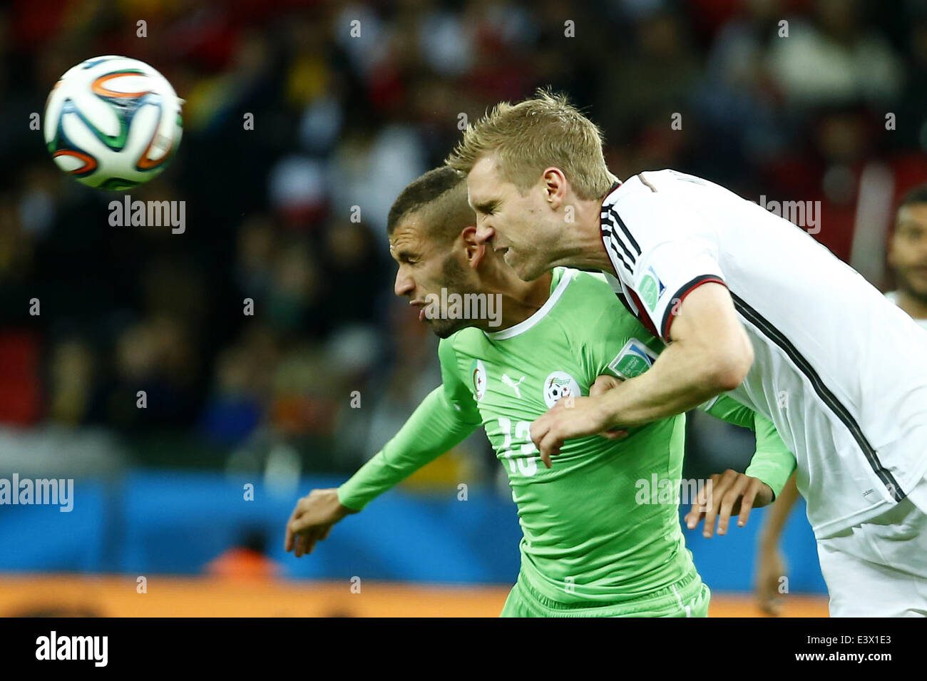 Porto Alegre, Brazil. 30th June, 2014. Germany's Per Mertesacker vies with Algeria's Islam Slimani during a Round of 16 match between Germany and Algeria of 2014 FIFA World Cup at the Estadio Beira-Rio Stadium in Porto Alegre, Brazil, on June 30, 2014. Credit:  Chen Jianli/Xinhua/Alamy Live News Stock Photo