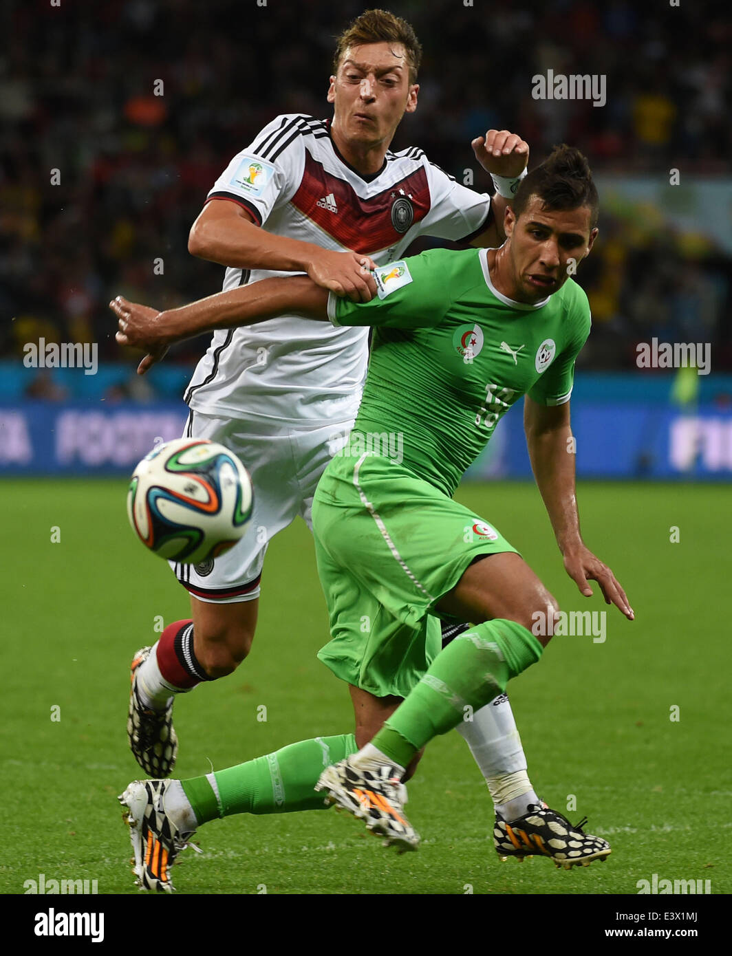 Porto Alegre, Brazil. 30th June, 2014. Algeria's Saphir Taider (R) vies with Germany's Mesut Ozil during a Round of 16 match between Germany and Algeria of 2014 FIFA World Cup at the Estadio Beira-Rio Stadium in Porto Alegre, Brazil, on June 30, 2014. Credit:  Li Ga/Xinhua/Alamy Live News Stock Photo