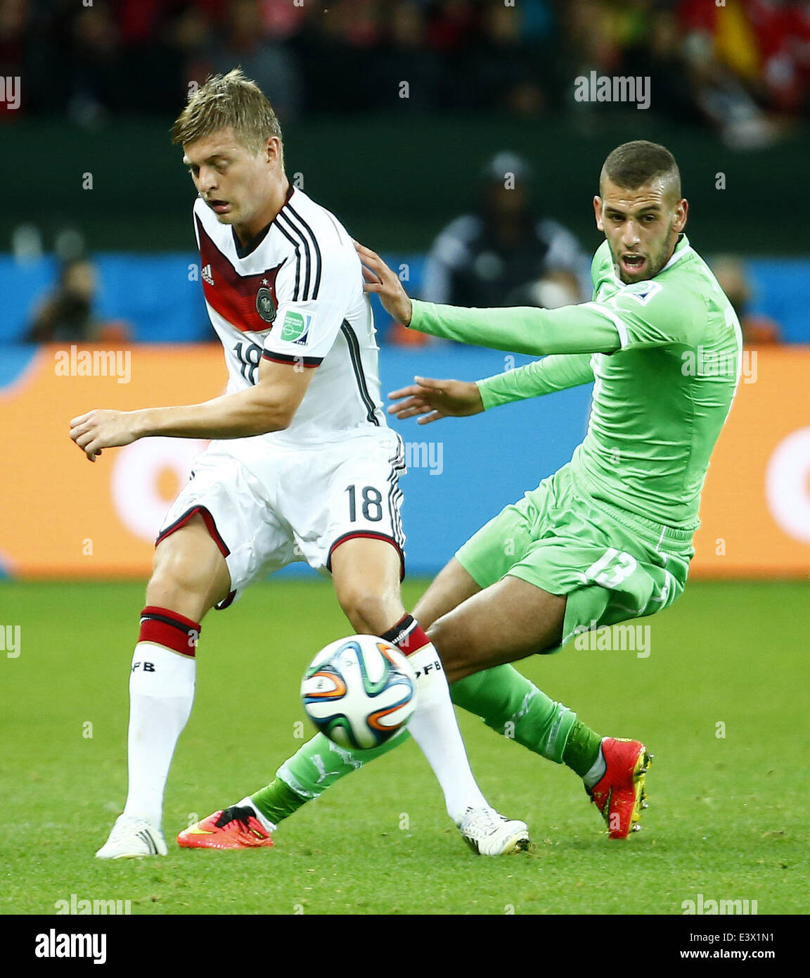 Porto Alegre, Brazil. 30th June, 2014. Germany's Toni Kroos vies with Algeria's Islam Slimani during a Round of 16 match between Germany and Algeria of 2014 FIFA World Cup at the Estadio Beira-Rio Stadium in Porto Alegre, Brazil, on June 30, 2014. Credit:  Chen Jianli/Xinhua/Alamy Live News Stock Photo