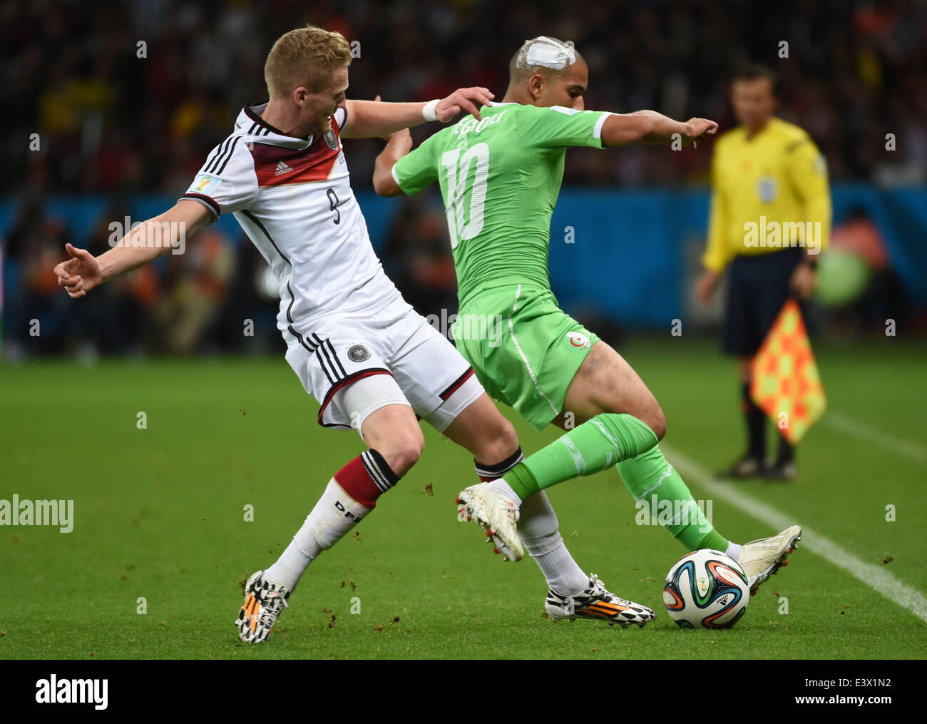 Porto Alegre, Brazil. 30th June, 2014. Algeria's Sofiane Feghouli (R) vies with Germany's Andre Schurrle during a Round of 16 match between Germany and Algeria of 2014 FIFA World Cup at the Estadio Beira-Rio Stadium in Porto Alegre, Brazil, on June 30, 2014. Credit:  Li Ga/Xinhua/Alamy Live News Stock Photo