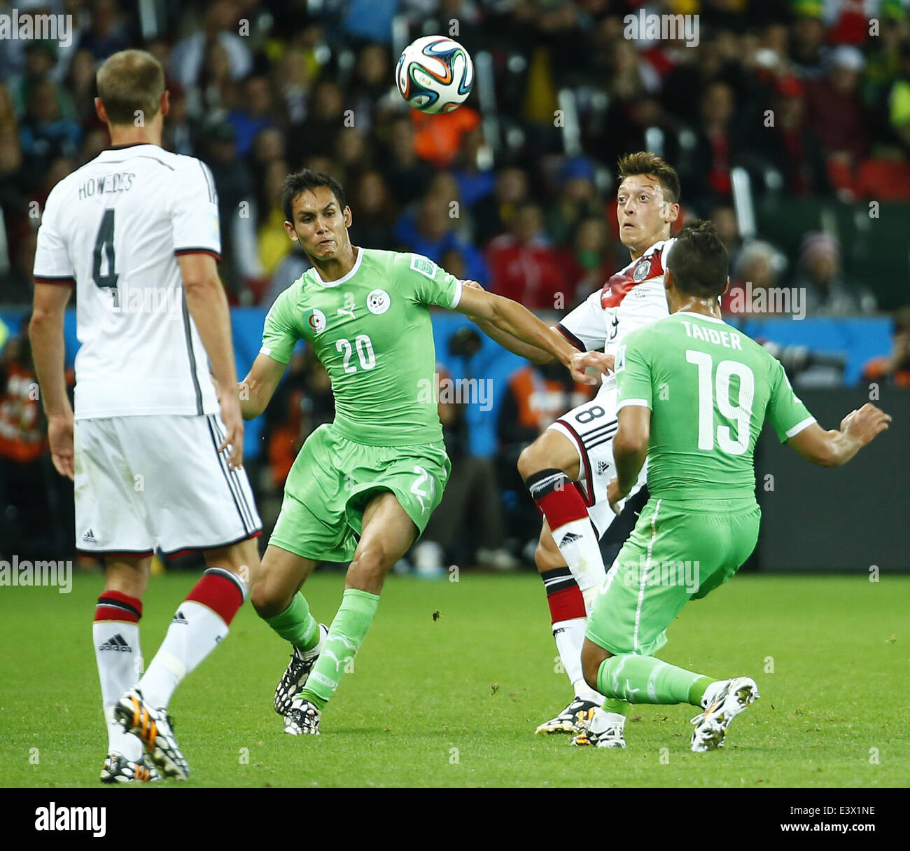 Porto Alegre, Brazil. 30th June, 2014. Germany's Mesut Ozil (2nd R) vies with Algeria's Aissa Mandi (2nd L) during a Round of 16 match between Germany and Algeria of 2014 FIFA World Cup at the Estadio Beira-Rio Stadium in Porto Alegre, Brazil, on June 30, 2014. Credit:  Chen Jianli/Xinhua/Alamy Live News Stock Photo
