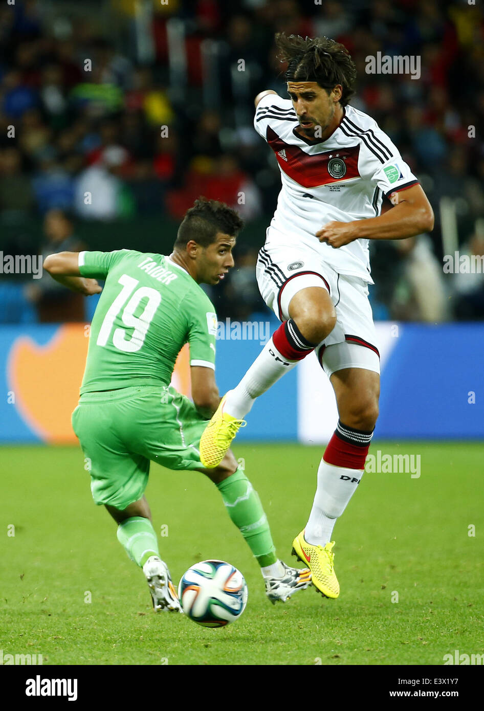 Porto Alegre, Brazil. 30th June, 2014. Germany's Sami Khedira vies with Algeria's Saphir Taider during a Round of 16 match between Germany and Algeria of 2014 FIFA World Cup at the Estadio Beira-Rio Stadium in Porto Alegre, Brazil, on June 30, 2014. Credit:  Chen Jianli/Xinhua/Alamy Live News Stock Photo