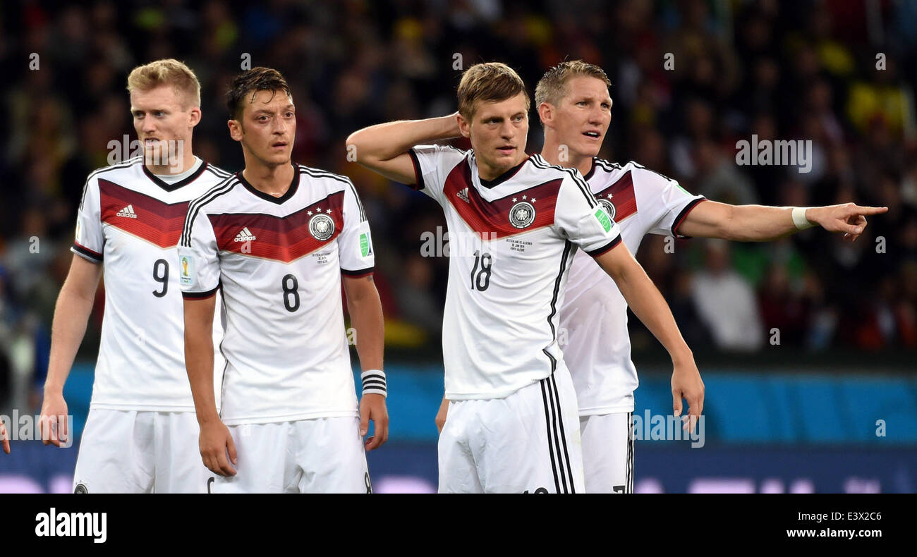 Porto Alegre, Brazil. 30th June, 2014. Germany's Andre Schurrle, Mesut Ozil, Toni Kroos and Bastian Schweinsteiger (from L to R) react during a Round of 16 match between Germany and Algeria of 2014 FIFA World Cup at the Estadio Beira-Rio Stadium in Porto Alegre, Brazil, on June 30, 2014. Credit:  Li Ga/Xinhua/Alamy Live News Stock Photo
