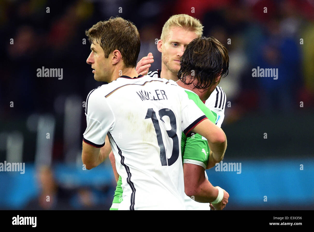 Porto Alegre, Brazil. 30th June, 2014. Germany's Thomas Mueller (L-R) and Andre Schurrle try to comfort Algeria's Mehdi Mostefa after the FIFA World Cup 2014 round of 16 soccer match between Germany and Algeria at the Estadio Beira-Rio in Porto Alegre, Brazil, 30 June 2014. Photo: Marcus Brandt/dpa/Alamy Live News Stock Photo