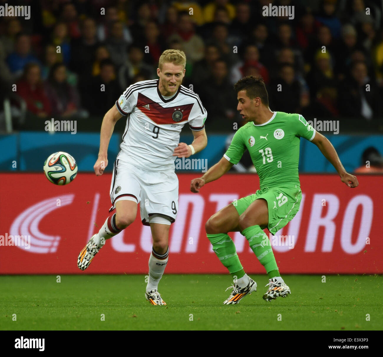 Porto Alegre, Brazil. 30th June, 2014. Algeria's Saphir Taider (R) vies with Germany's Andre Schurrle during a Round of 16 match between Germany and Algeria of 2014 FIFA World Cup at the Estadio Beira-Rio Stadium in Porto Alegre, Brazil, on June 30, 2014. Germany won 2-1 over Algeria after 120 minutes and qualified for quarter-finals on Monday. Credit:  Li Ga/Xinhua/Alamy Live News Stock Photo