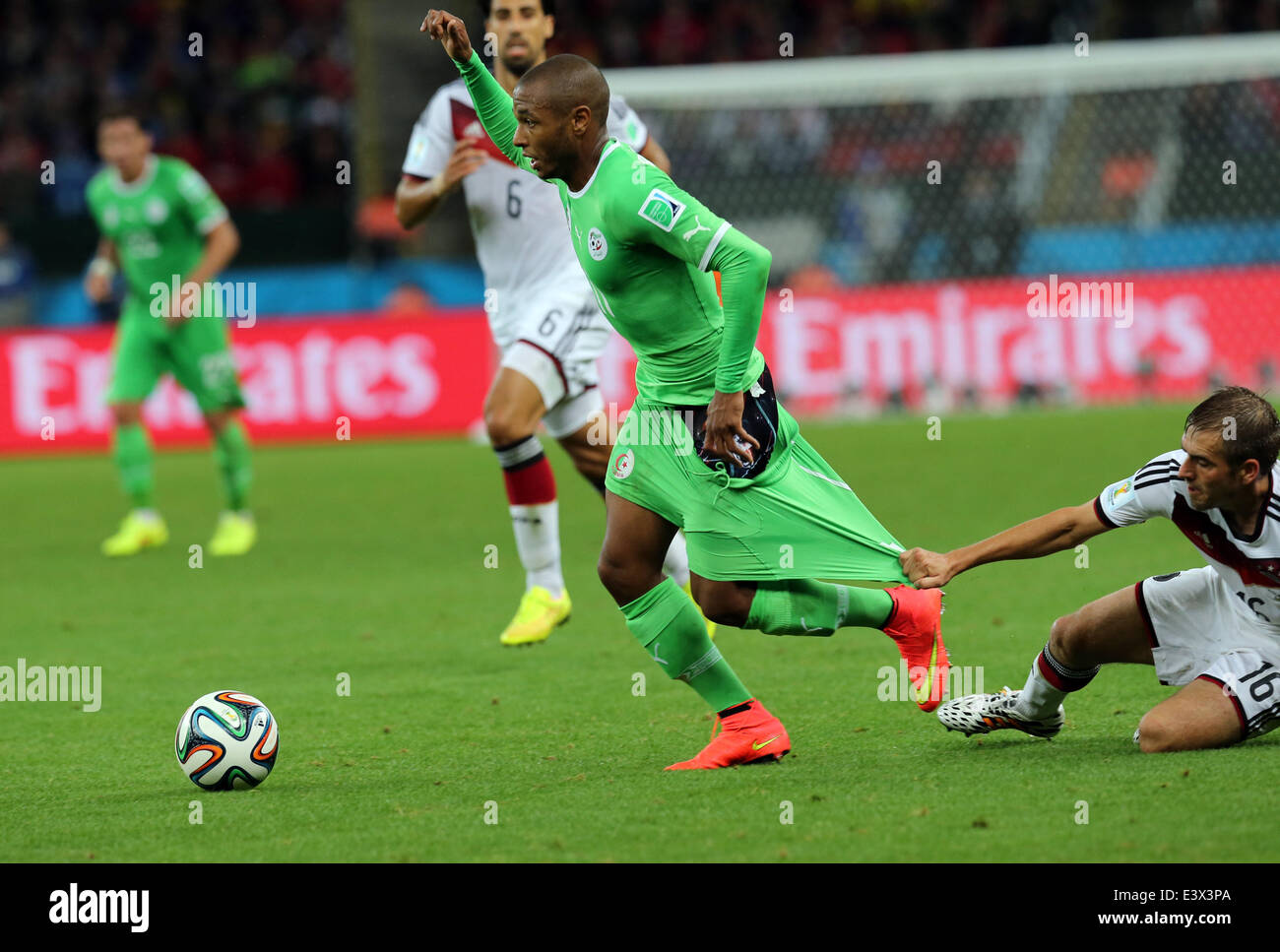 Porto Alegre, Brazil. 30th June, 2014. World Cup 2nd Round. Germany versus Algeria. Brahimi is pulled back by Lahm who receives a yellow card Credit:  Action Plus Sports/Alamy Live News Stock Photo