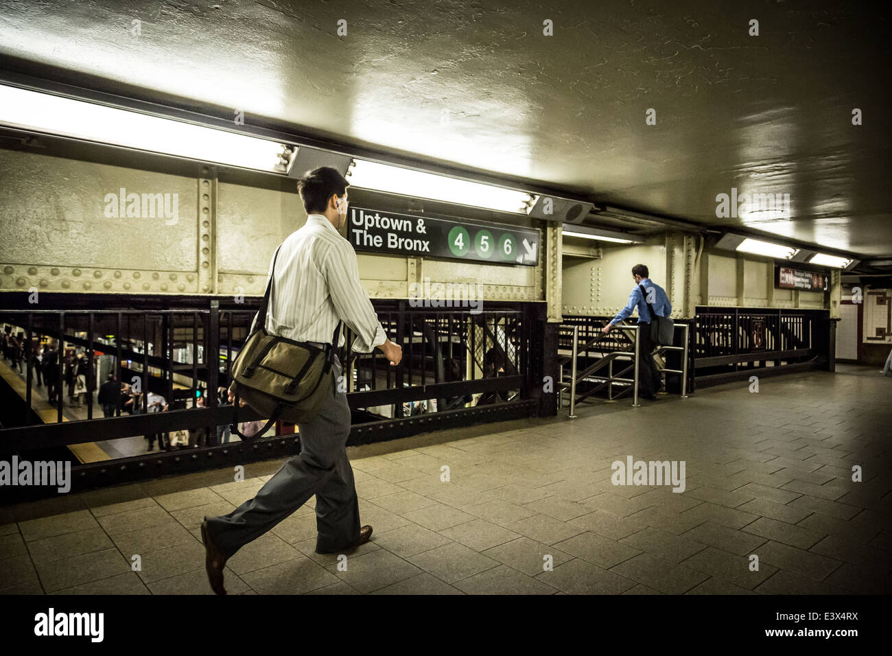 Young businessmen running to catch 4 5 6 Train in Manhattan New York ...