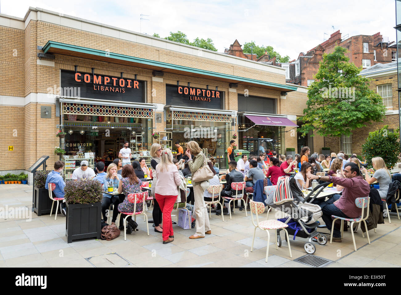 People eating outside at Lebanese restaurant, Comptoir Libanais in Duke Of York Square, Chelsea, London, England, UK Stock Photo