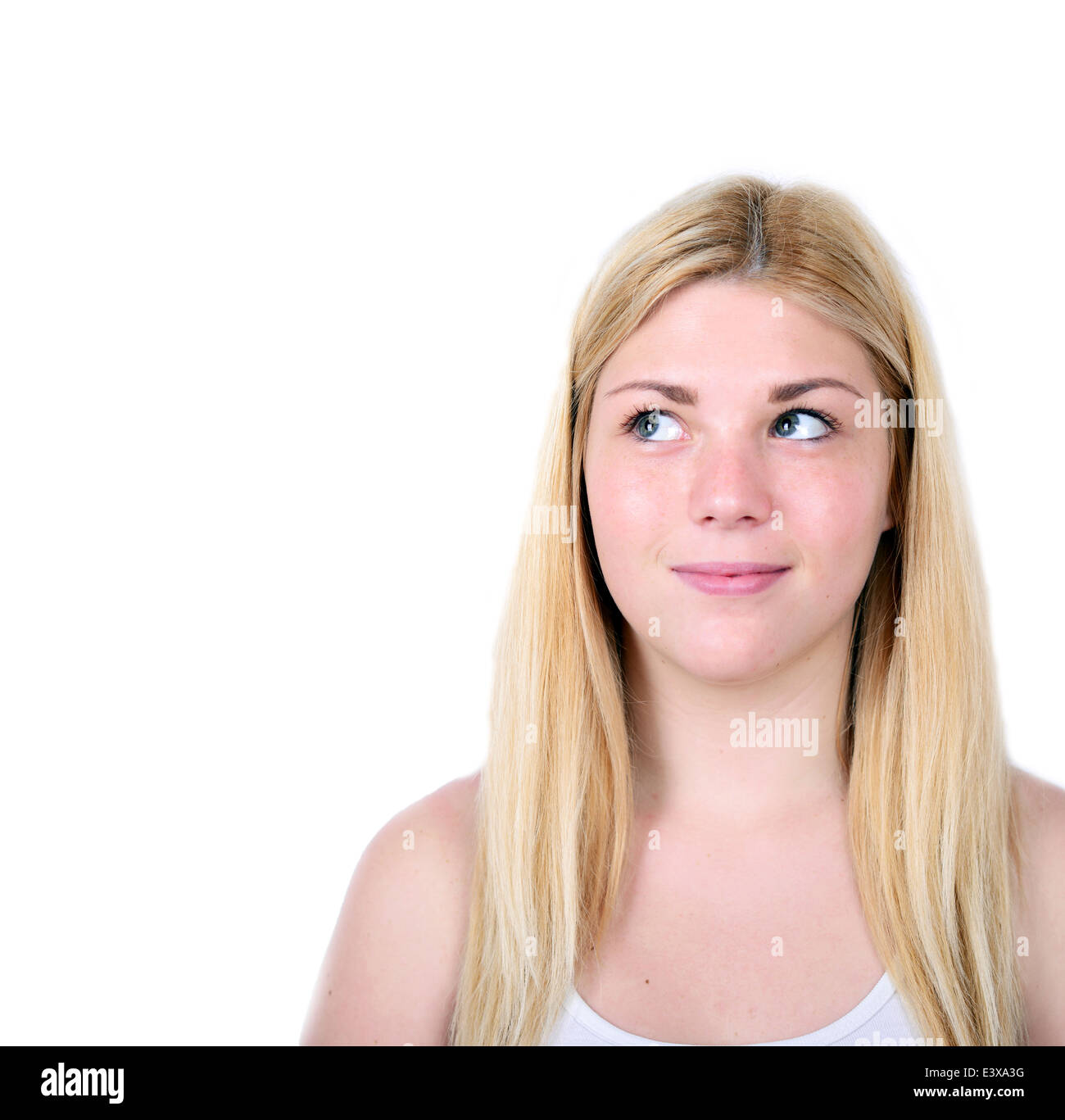 Portrait of beautiful girl thinking and looking up against white ...