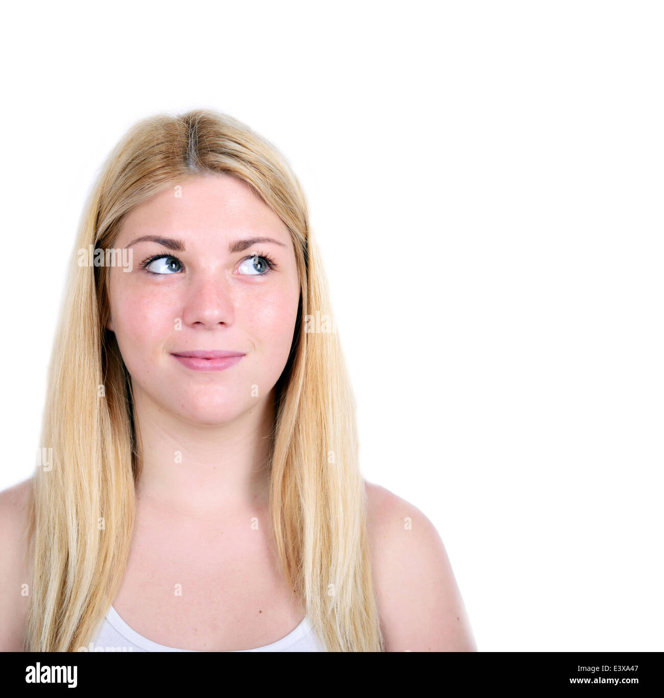 Portrait of beautiful girl thinking and looking up against white ...