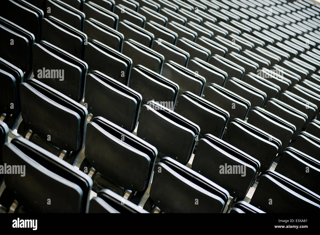 Rows of empty seats for spectators at a football ground. Stock Photo