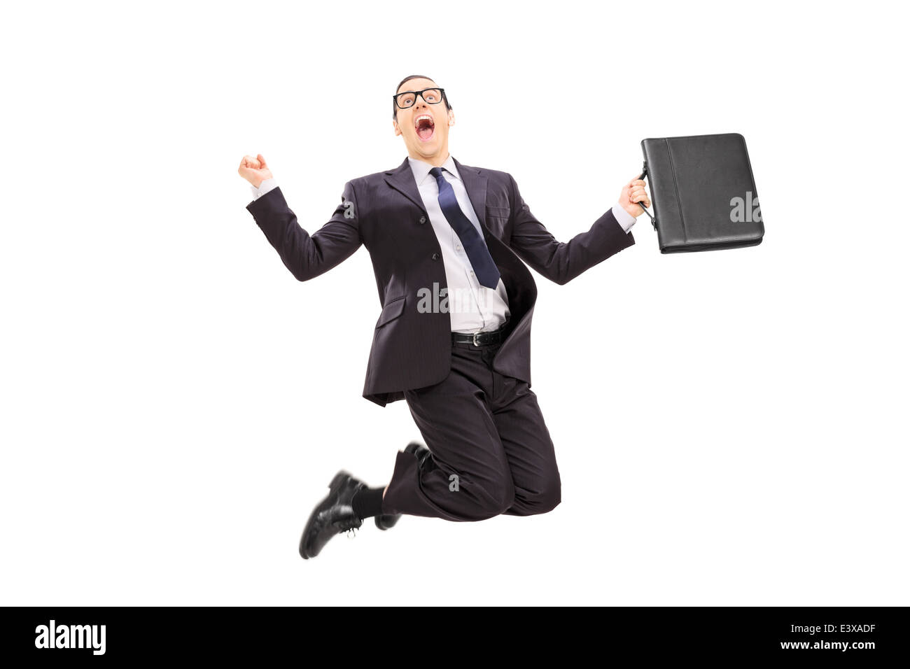 Businessman with briefcase jumping out of joy Stock Photo - Alamy