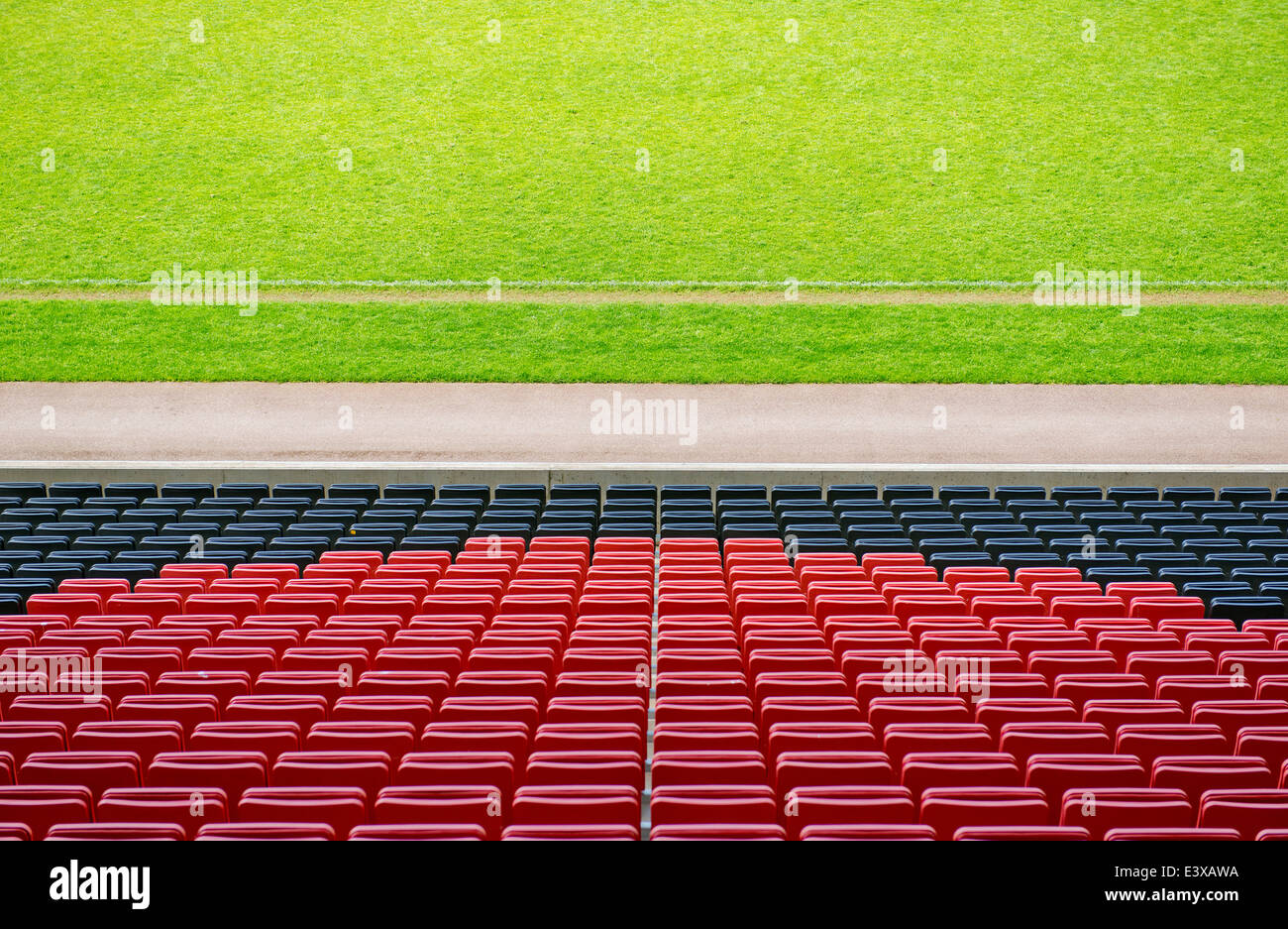 Rows of empty seats for spectators at a football ground. Stock Photo