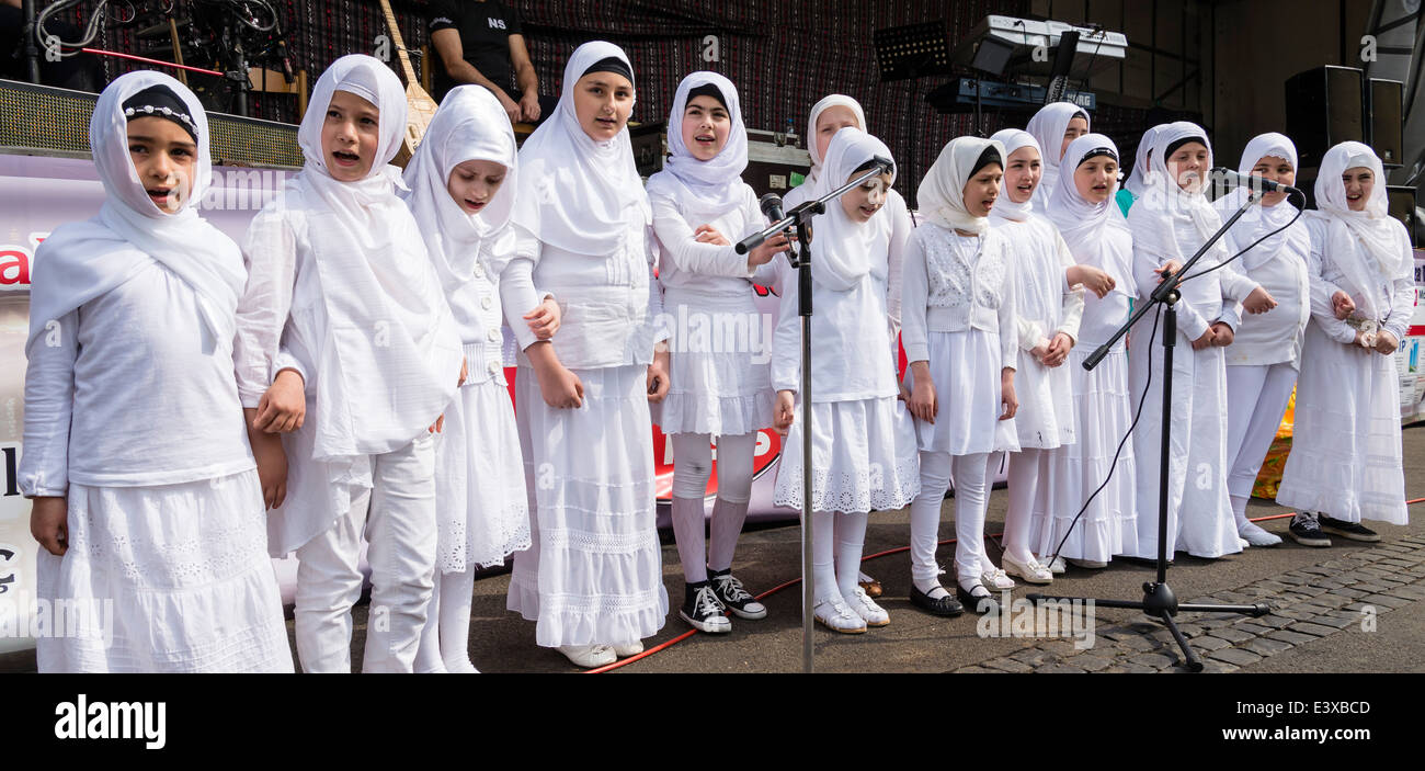 Young girls of Turkish origin who live in Germany sing religious songs, wearing traditional Turkish clothes. Stock Photo