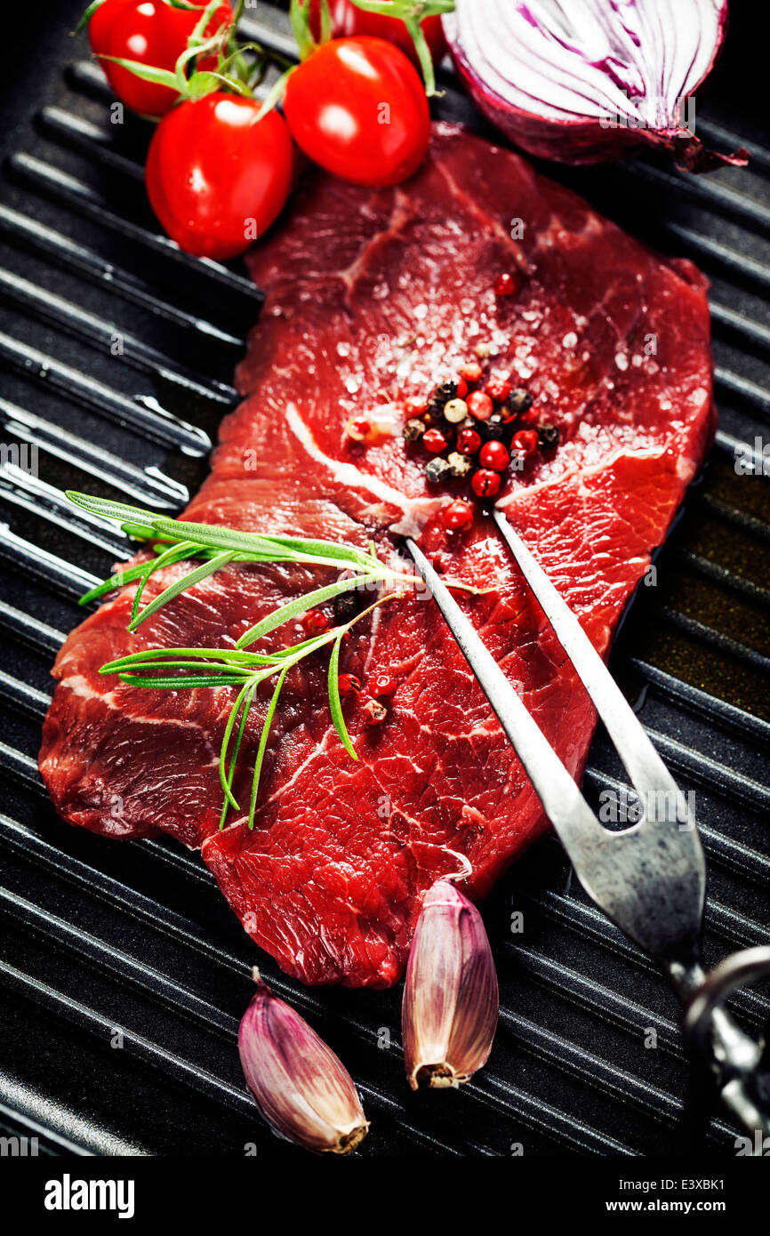 Marbled beef steak with meat fork and vegetables in a grill pan Stock