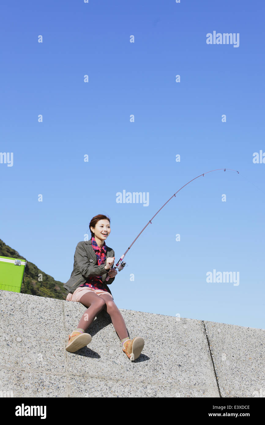 Woman with fishing pole hi-res stock photography and images - Alamy