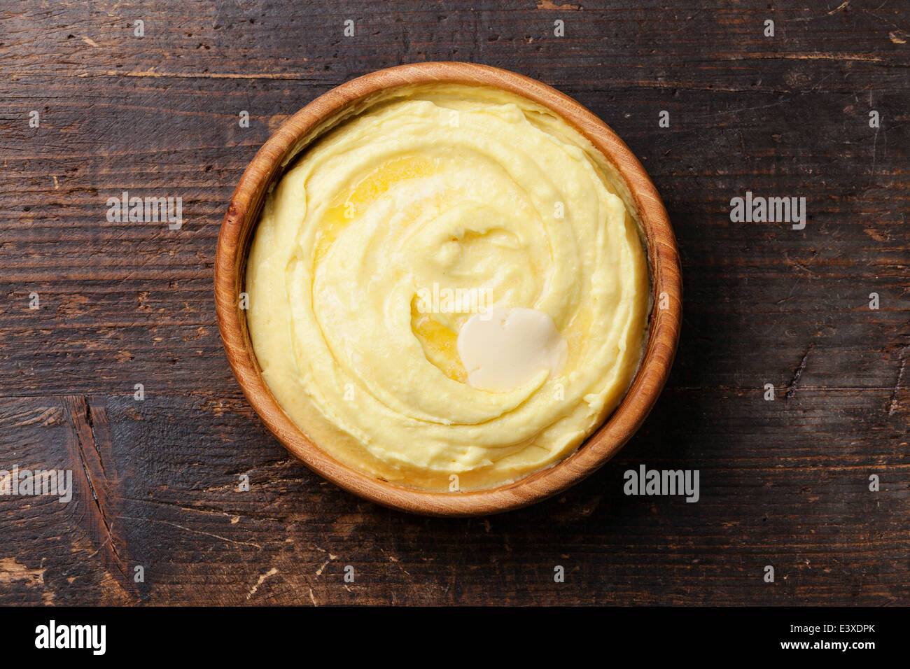 Mashed potatoes in wooden bowl on dark background Stock Photo