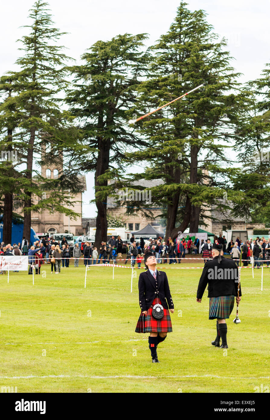 LADY DRUM MAJOR KEEPS AN EYE ON A MACE AT FORRES SCOTLAND EUROPEAN PIPE BAND CHAMPIONSHIPS JUNE 2014 Stock Photo