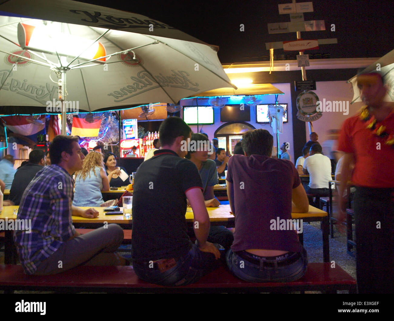 Erbil, Iraq. 30th June, 2014. Guests sit in a beer garden run by Germans and watch the FFA World Cup match Germany vs Algeria in Erbil, Iraq, 30 June 2014. Photo: MEY DUDIN/DPA/Alamy Live News Stock Photo