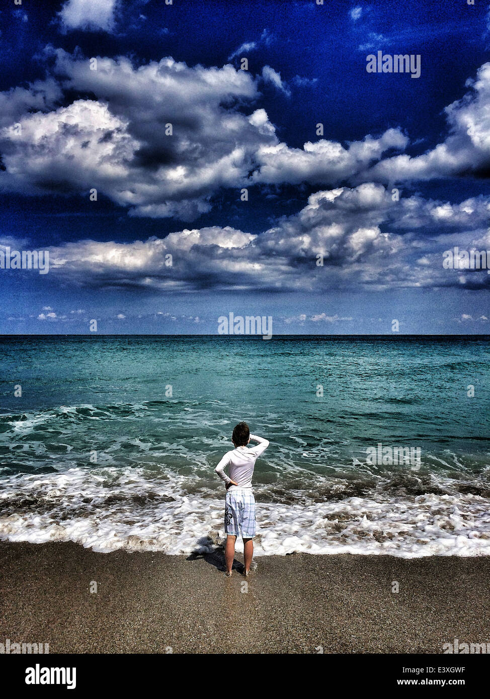 Woman standing in waves at beach - Smartphone Captured Stock Image Woman standing in waves at beach - Smartphone Captured Stock Image