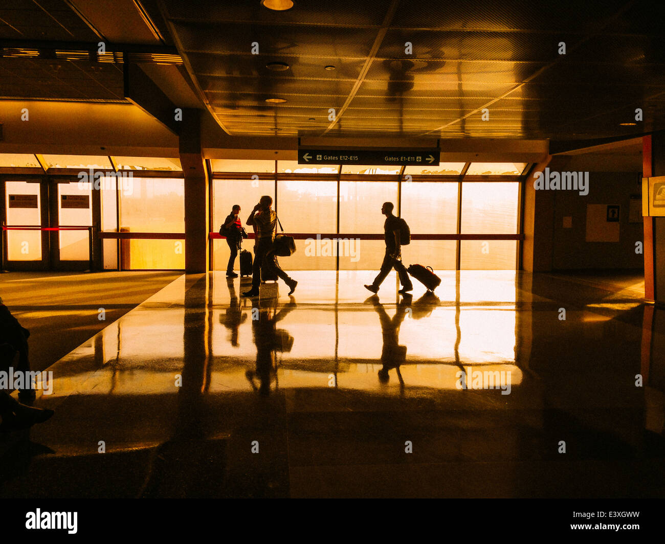 Silhouette of people walking in airport terminal - Smartphone Captured Stock Image