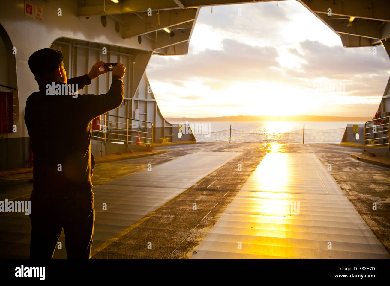 Man taking picture out ferry gate Stock Photo