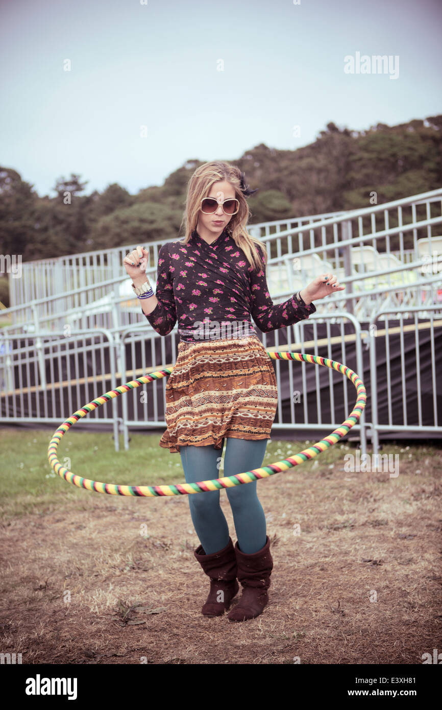 Woman playing with hula hoop at festival Stock Photo