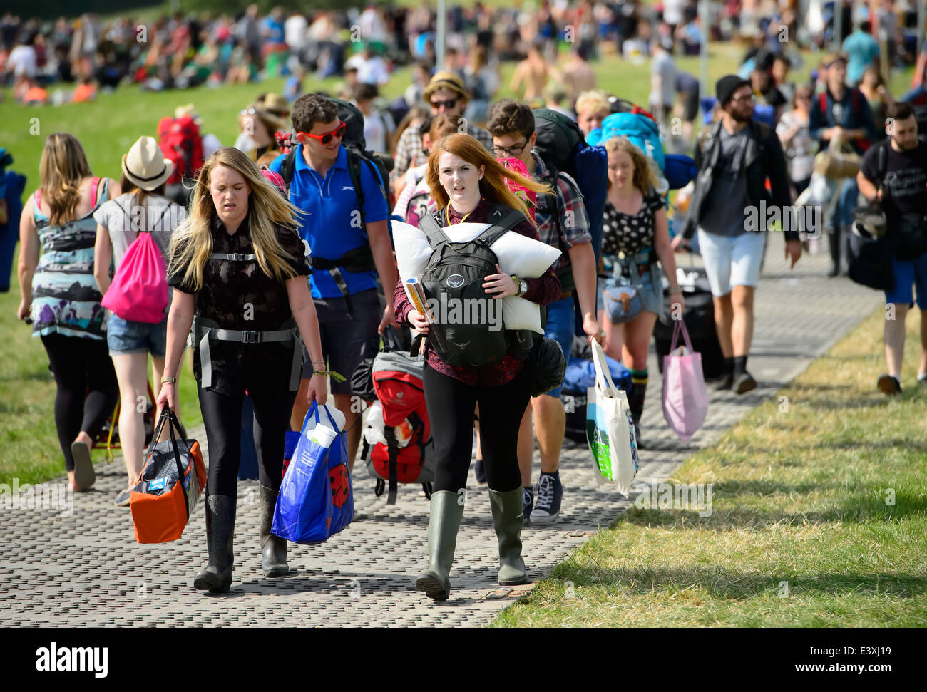 Festival goers arrive at Glastonbury music festival, England, Wednesday