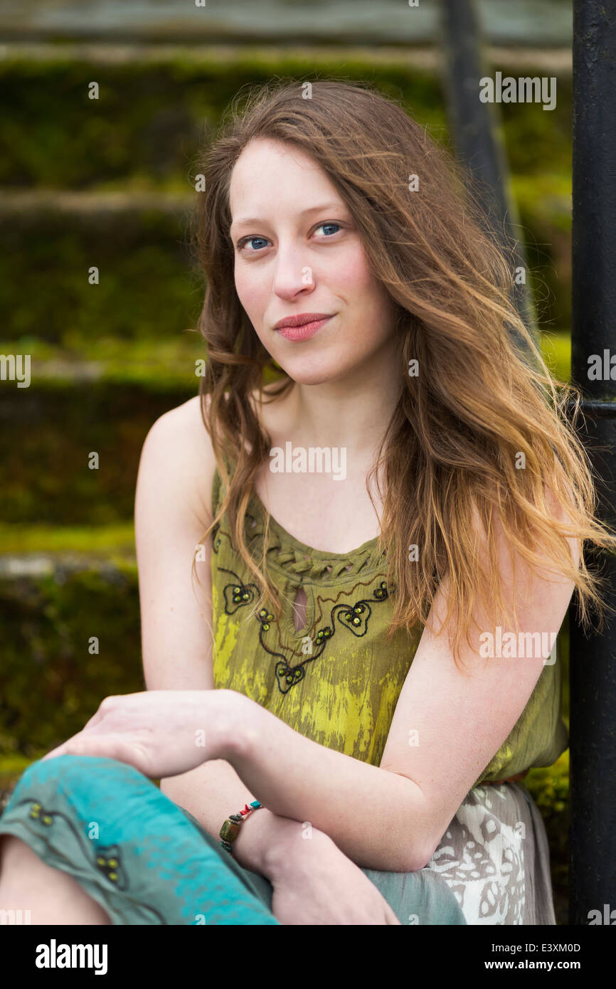 Caucasian teenage girl sitting on steps outdoors Stock Photo