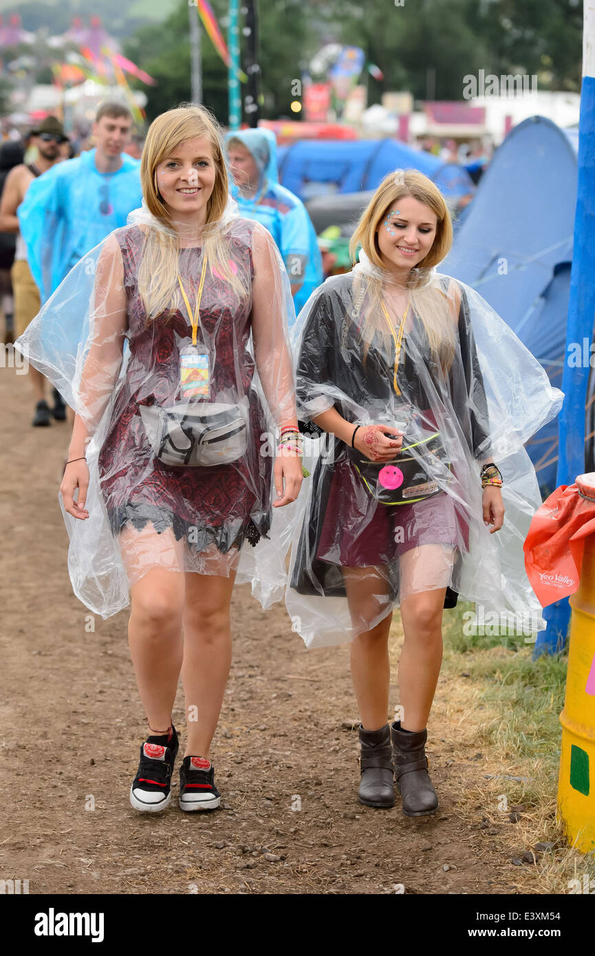 Festival goers during rain at Glastonbury music festival, England, Friday, June 27, 2014 Stock