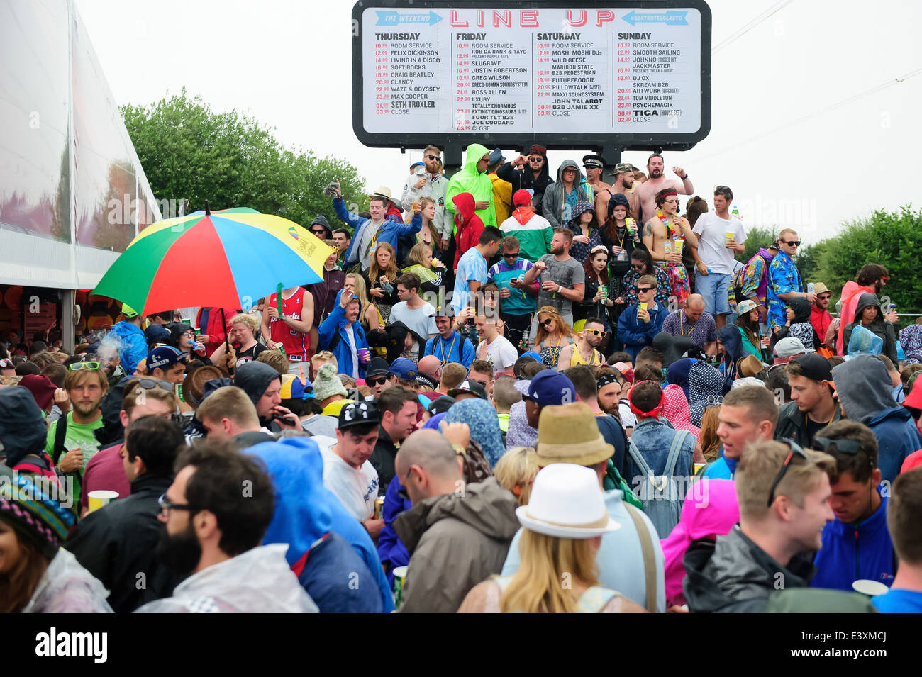 Festival goers during rain at Glastonbury music festival, England