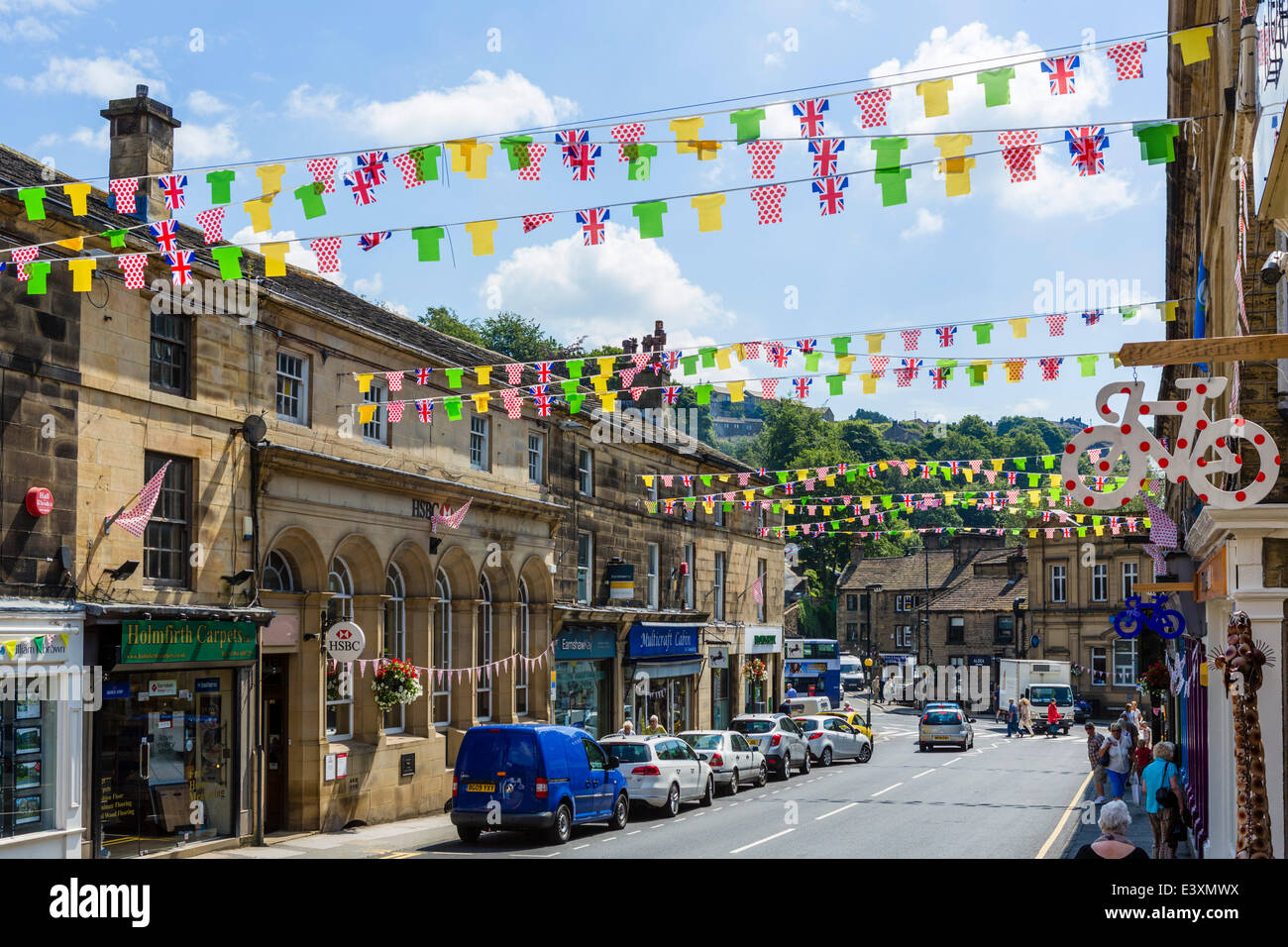 The West Yorkshire village of Holmfirth gets into the spirit of the 2014 Tour de France, Stage 2 of which passes through the town on Sunday 6th July 2014. Bunting is strung along along all the streets as in this shot of Victoria Street in the town centre. Stock Photo