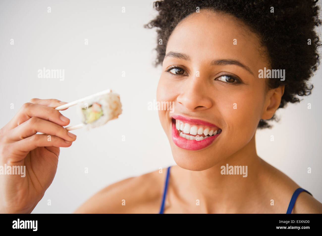 Black woman eating sushi Stock Photo Alamy