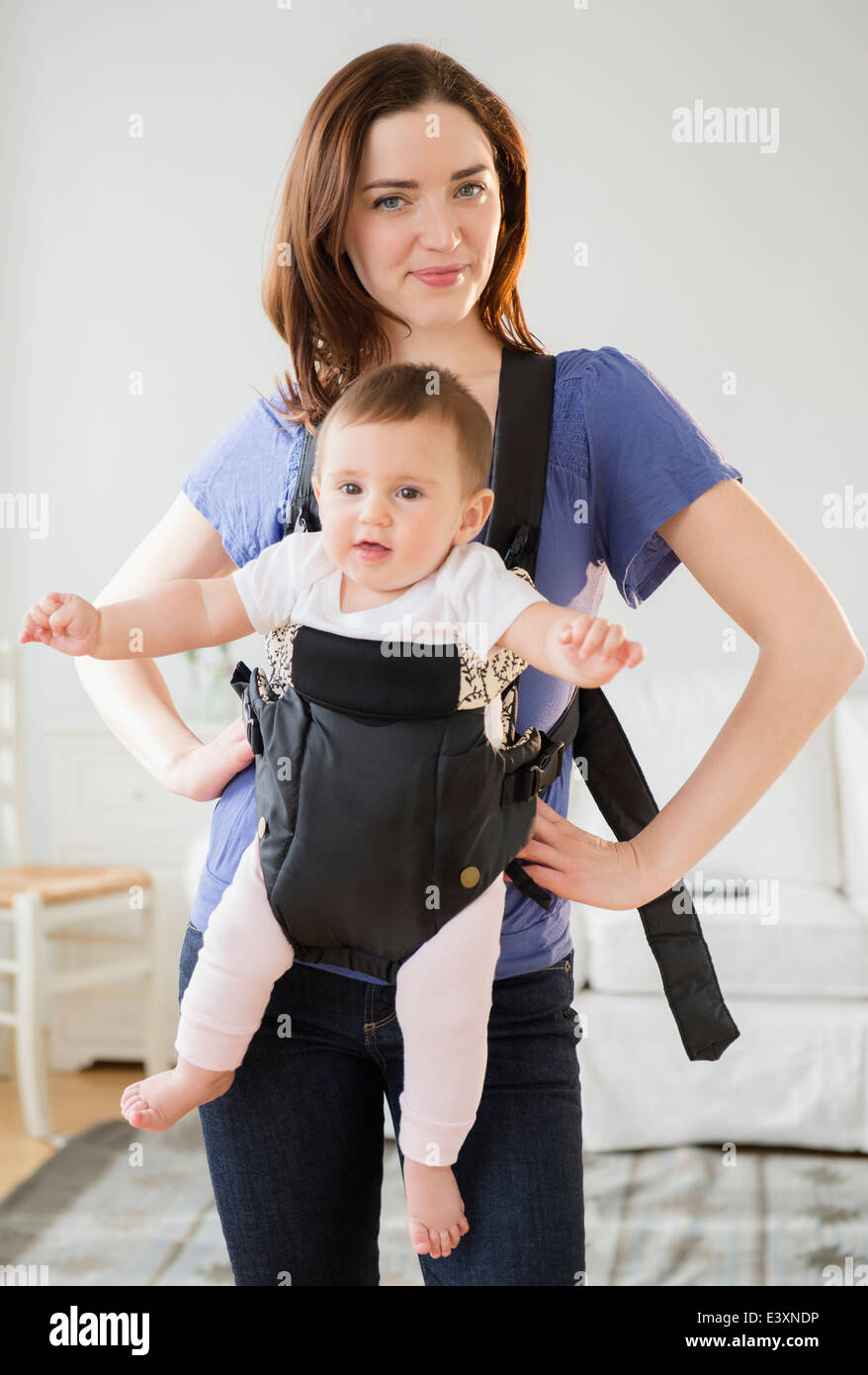 Mother carrying baby in sling Stock Photo