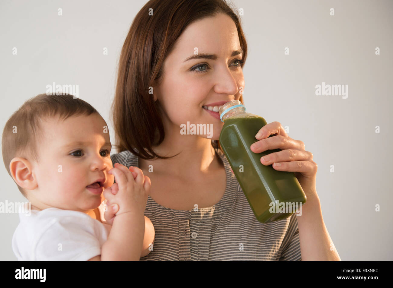 Close up girl drinking juice mother hires stock photography and images