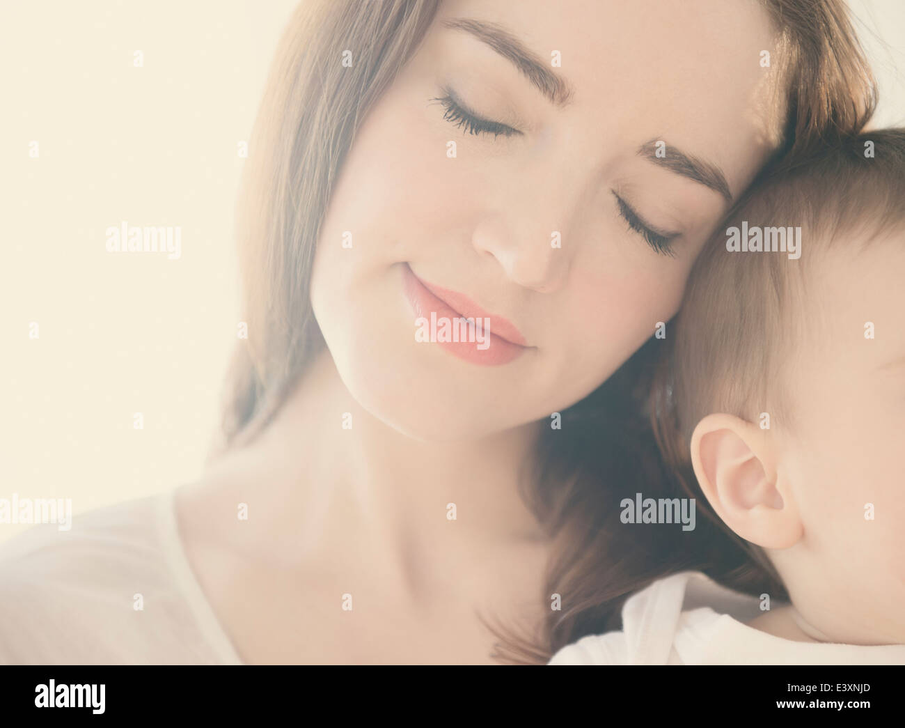Smiling mother cradling baby Stock Photo