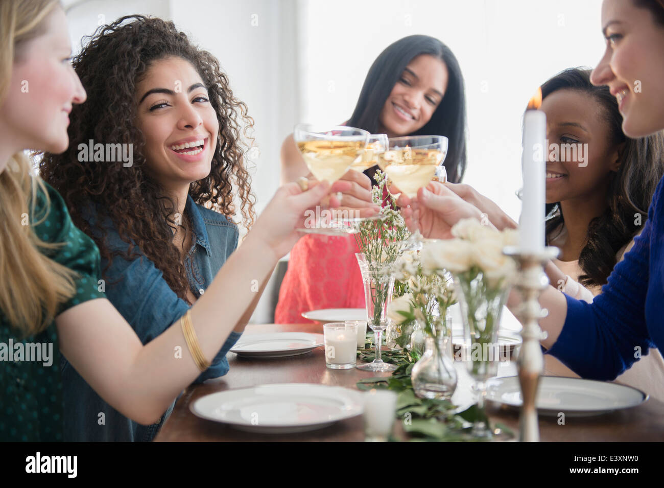 Women toasting each other with champagne Stock Photo