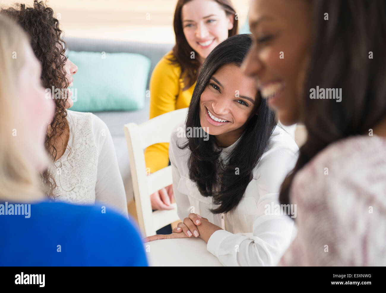 Women relaxing together in living room Stock Photo