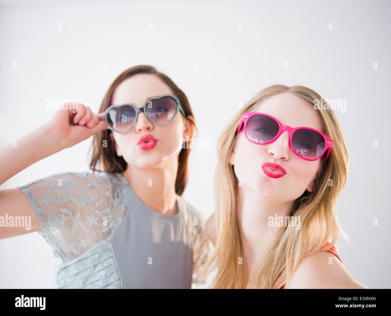 Women wearing colorful sunglasses and lipstick Stock Photo