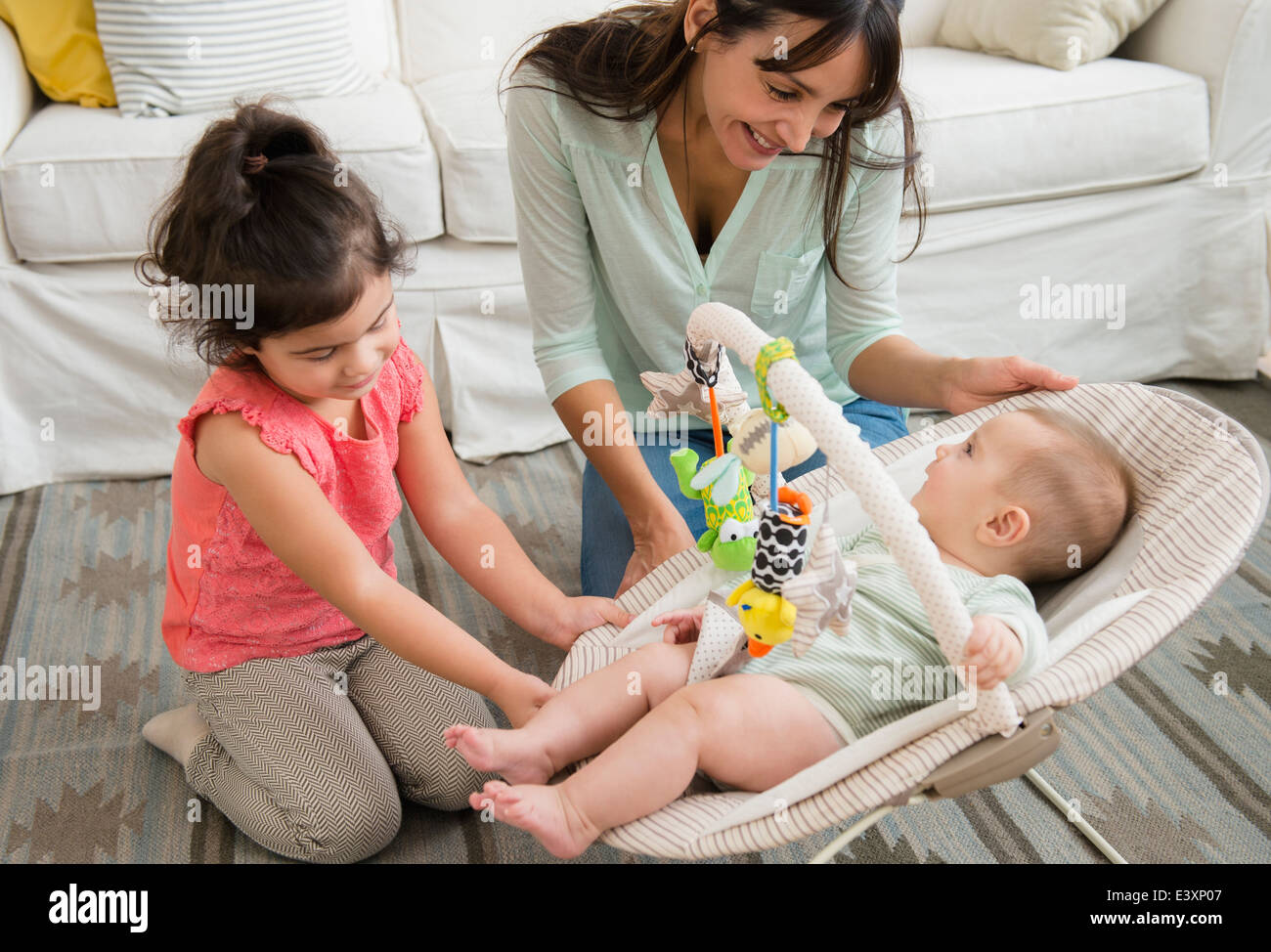 Family relaxing together in living room Stock Photo