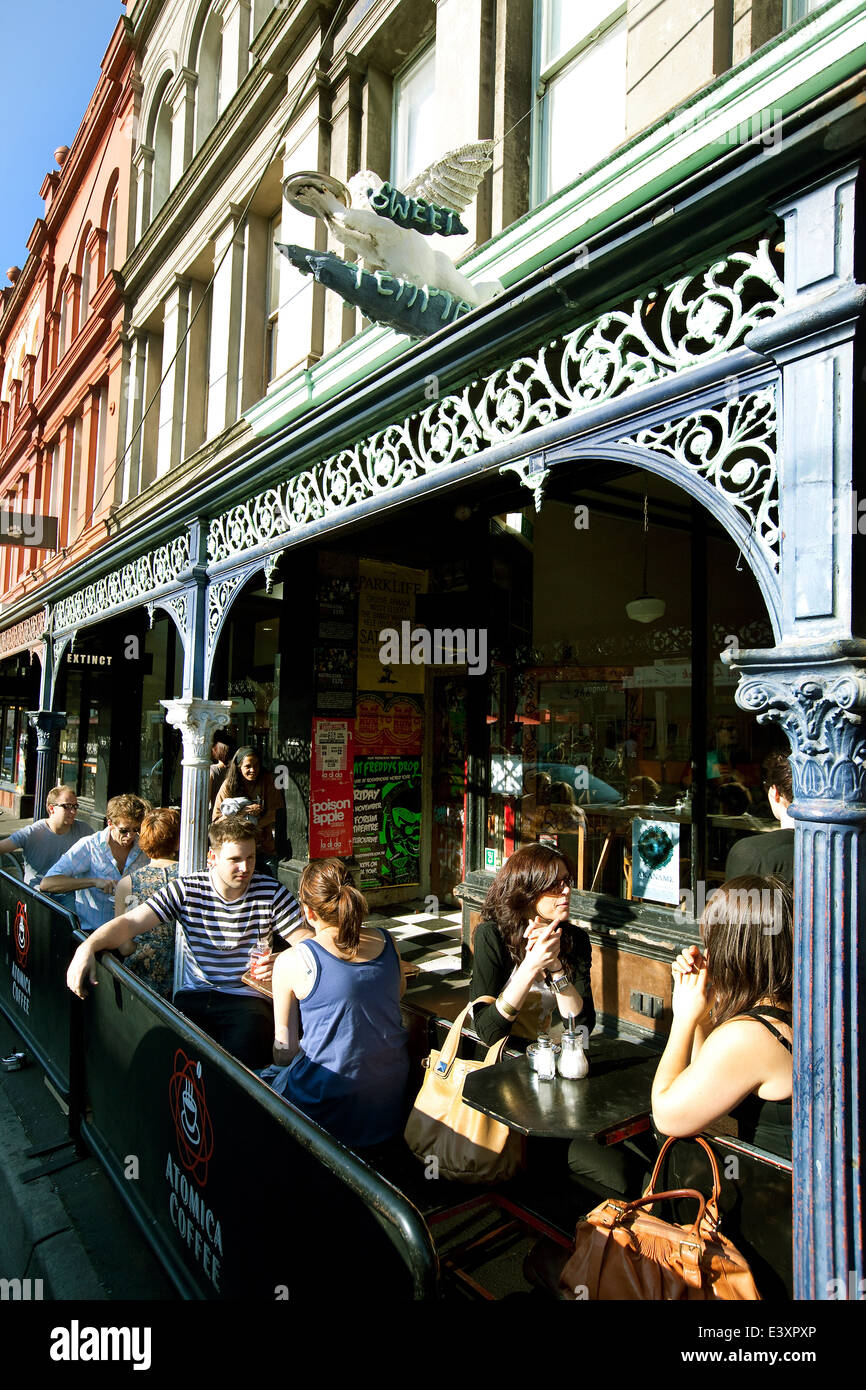 Melbourne Fitzroy scene Brunswick  st cafe culture, people drinking coffee on street. metal iron work old historical building. Stock Photo